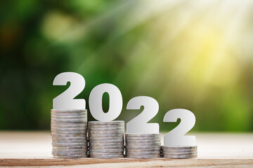 2022 New year on coins stack for saving money and financial planning concept