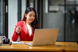 © David - Shot of an Asian young business Female working on laptop computer in her workstation.Portrait of Business people employee freelance online marketing e-commerce telemarketing concept.