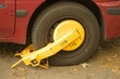 Car blocked by a yellow wheel clamp