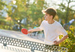 © Kadmy - boy playing table tennis ping pong outdoors