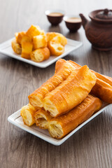 Youtiao.  Long golden brown deep fried dough strip.