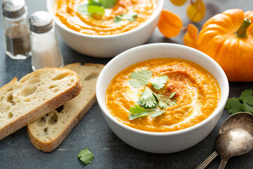 Canvas Print - Pumpkin soup served with cream and cilantro