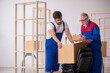 © Elnur - Two male professional movers doing home relocation