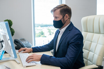Poster - Young Caucasian white collar worker working in front of computer in office