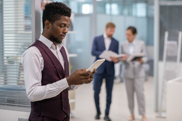 Poster - Young well-dressed businessman or broker with tablet looking through online financial data