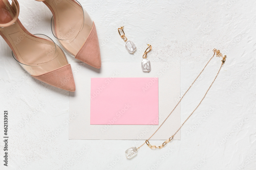 Blank card with jewelry and shoes on white background