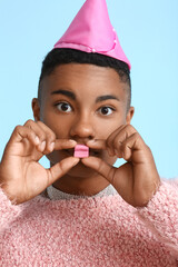 Poster - Glamorous African-American guy with chewing gum on color background