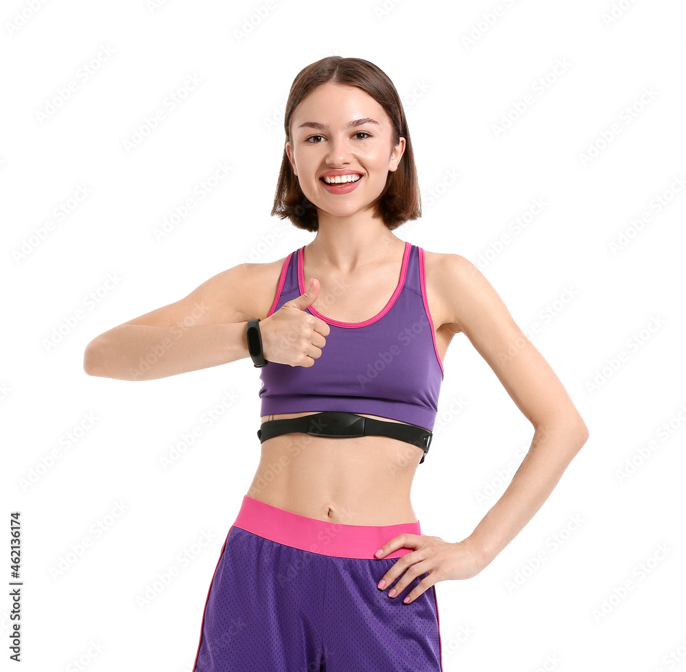Sporty female runner checking pulse on white background