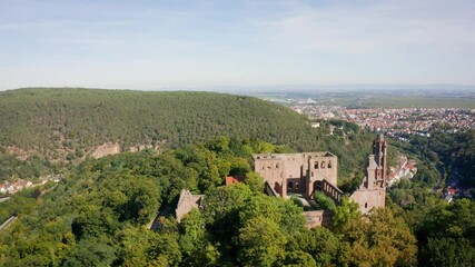 Wall Mural - Aerial view of a monastery ruin with Bad Dürkheim in the background on a sunny day in Germany. Aerial vie 4k