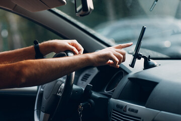 Navigator in car vehicle transportation commuter. Driver man using mobile phone navigator app driving car.
