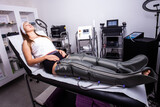 Fototapeta  - woman legs treatment with presoterapy   air compression leg massager pants
