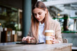 © Westend61 - Female business professional using digital tablet at cafe table