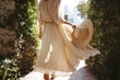 © Jacob Lund - Unrecognizable tourist woman walking in a flowy dress outdoors