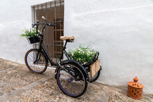 Tricycle Loaded With Flower Pots Decorating A Street In Vejer De La Frontera, A Beautiful White Town In Spain