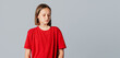 © Red Cristal - upset brunette teen girl looks away like she is very disappointed, very sad or doesn't want to hear anything, standing over gray background. Copy space