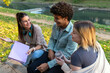© Red Riding Hood - Group of diverse students outside smiling together and studying in park