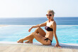 © Angelov - Middle-aged woman sitting near the pool