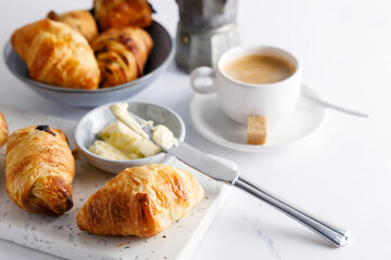 Canvas Print - Morning breakfast with croissants. Breakfast table with croissants and coffee, on a marble stone table.