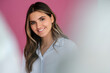 © Westend61 - Smiling female business professional with brown hair in front of wall