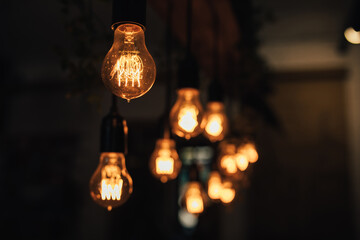 Lamp bulbs hanging on a dark background.