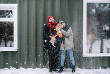 Cute Couple Posing For A Photo With Their Beagle Outdoors At Winter