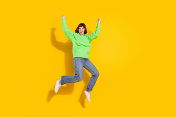 Poster - Full length photo of happy charming attractive woman jump up winner isolated on shine yellow color background