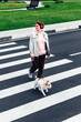© Westend61 - Smiling woman with Jack Russell Terrier crossing road