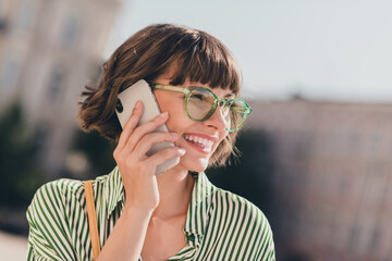 Poster - Photo of sociable pretty businesswoman make call have conversation wear glasses striped shirt urban city outside