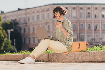 Poster - Photo of freelancer businesswoman sit street work netbook drink coffee wear specs striped shirt urban city outside