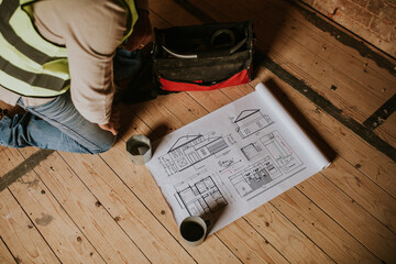 Wall Mural - Contractor reading floor plan at a construction site