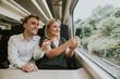 © Rawpixel.com - Couple by the train window taking photo of the scenery