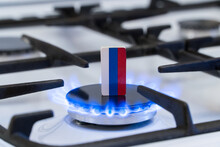 Shortage And Gas Crisis. Flag Of The Russian On A Burning Gas Stove