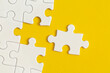 © LunaKate - White details of puzzle on yellow background. Business strategy, teamwork.
