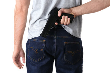 Man holding gun behind his back on white background, closeup