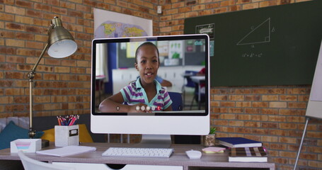 Poster - Webcam view of african american school girl on image call on computer on table at school