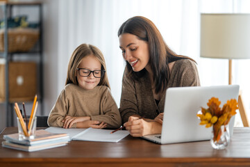 Wall Mural - Girl doing homework or online education.