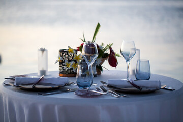 Wall Mural - Romantic dinner setting on the beach at sunset