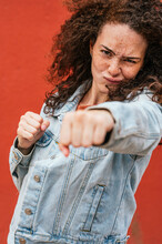Young Woman Punching With Fist While Making Face