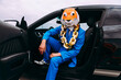 © VISTA by Westend61 - Funny character in animal mask and blue business suit sitting in car
