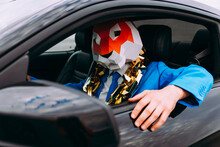 Funny Character Wearing Animal Mask And Blue Business Suit In Car