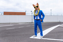 Funny Character Wearing Animal Mask And Blue Business Suit Having Fun On Empty Parking Lot