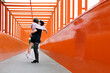 © VISTA by Westend61 - Teenage couple kissing on orange bridge