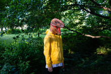 Pre-adolescent Boy Wearing Dinosaur Mask
