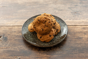 Delicious vegan cookies with chocolate chips on vintage wooden table