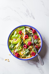 Canvas Print - Green broccoli salad with raspberries, nuts, avocado and tahini dressing. Vegan food concept.