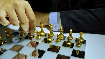 Poster - Businessman hand moving piece of chess on chess board, business concept