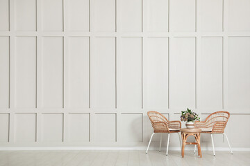 Sticker - Simple room interior with set of wicker furniture, beautiful flowers and empty wall. Space for design