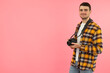© Atlas - Young man with photo camera on pink background, space for text