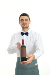 Wall Mural - Young man waiter holds bottle of wine, isolated on white background