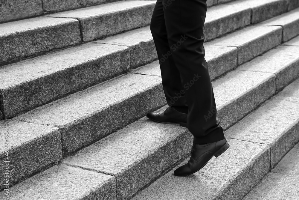 Businessman walking up the stairs outdoors